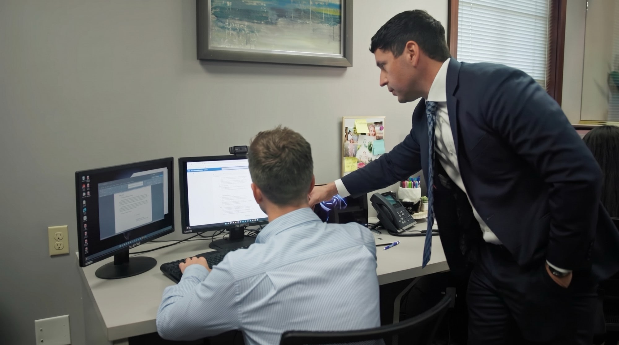 Attorney Chris Corzo working with a member of his legal team at the office