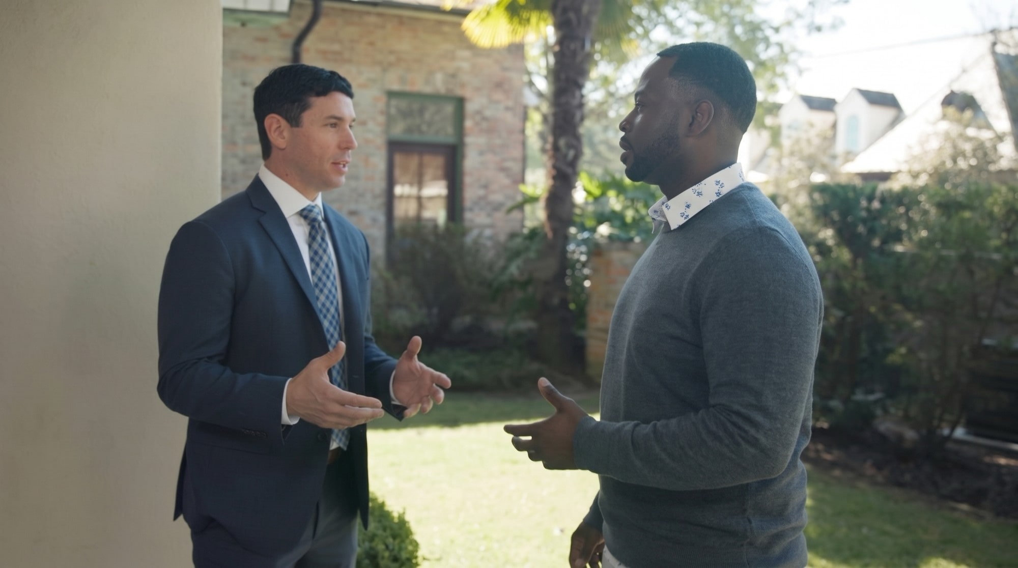 Personal injury attorney Chris Corzo talking with a client outdoors