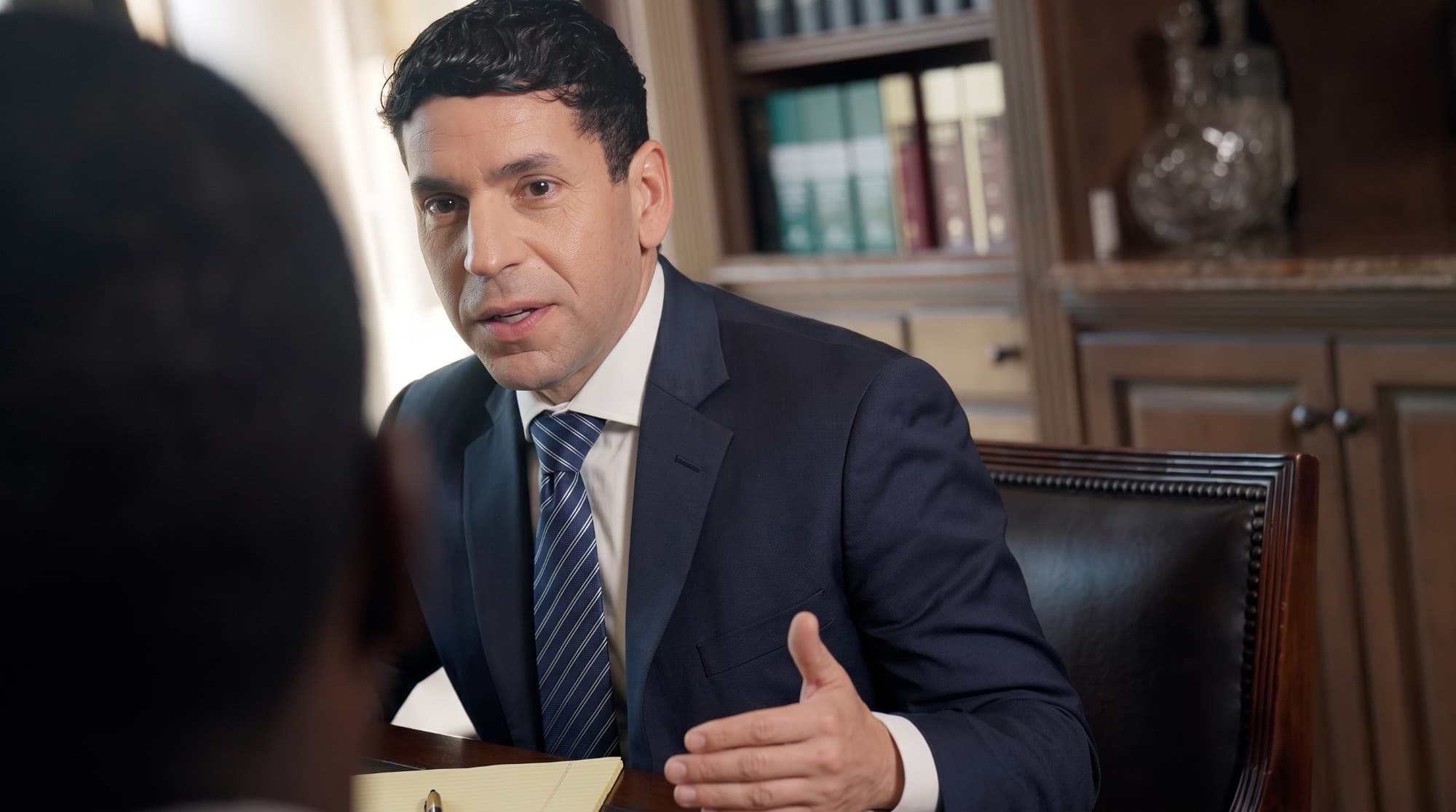 Attorney Chris Corzo talking with a client across his desk