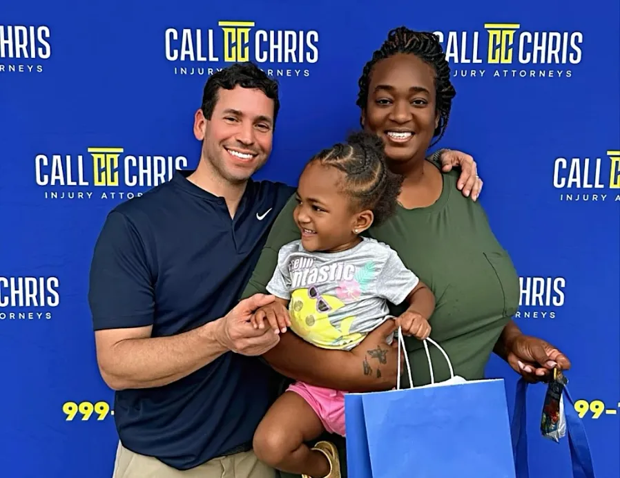 Chris Corzo with a mother and her daughter at a Corzo Cares event